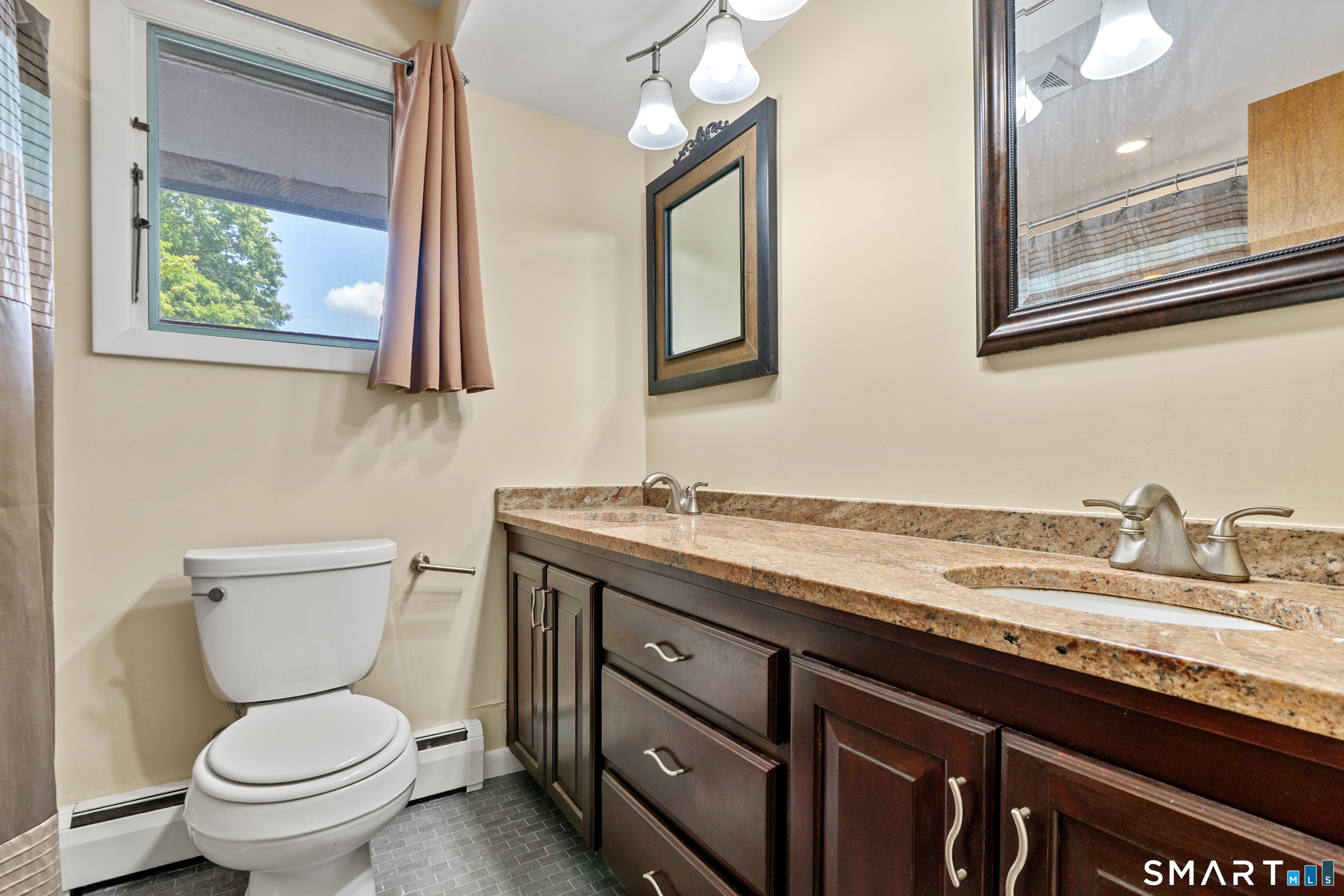 107 Round Hill Road Wethersfield, CT 06109 - Photo 29 of 40 a bathroom with a granite countertop toilet sink and a mirror