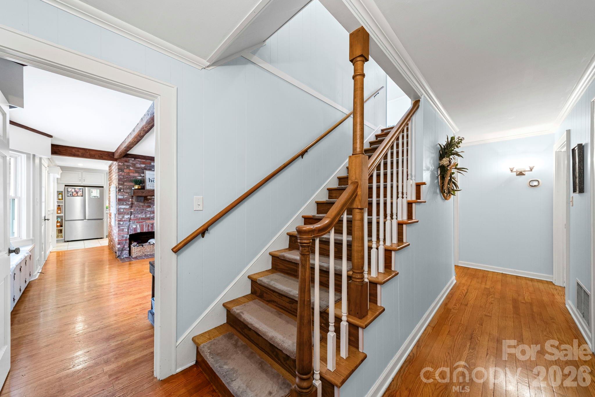 417 Park Ridge Road Albemarle, NC 28001 - Photo 20 of 47 a view of staircase with lots of frames on wall and wooden floor