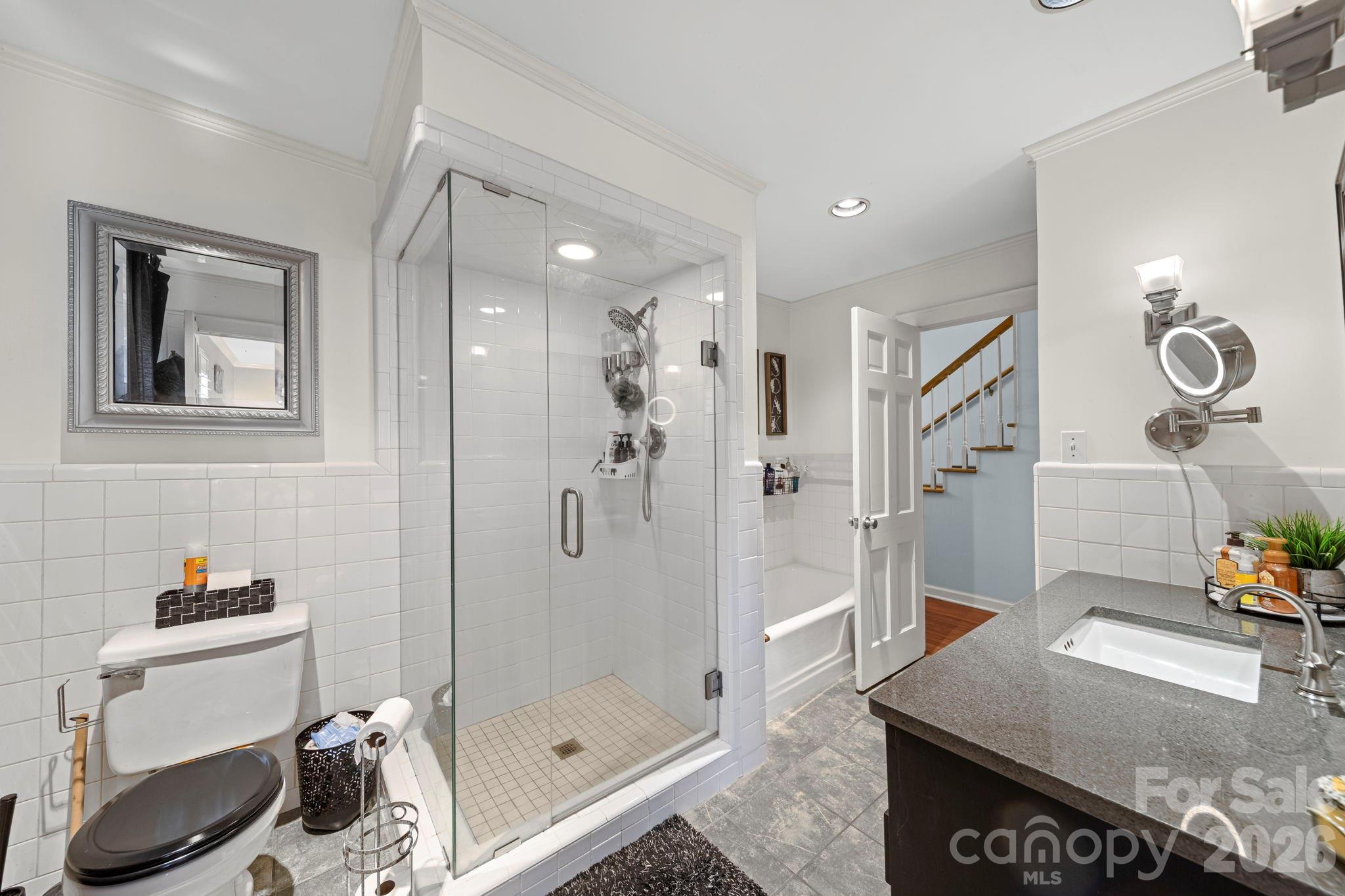 417 Park Ridge Road Albemarle, NC 28001 - Photo 23 of 47 a bathroom with a granite countertop sink a toilet and shower