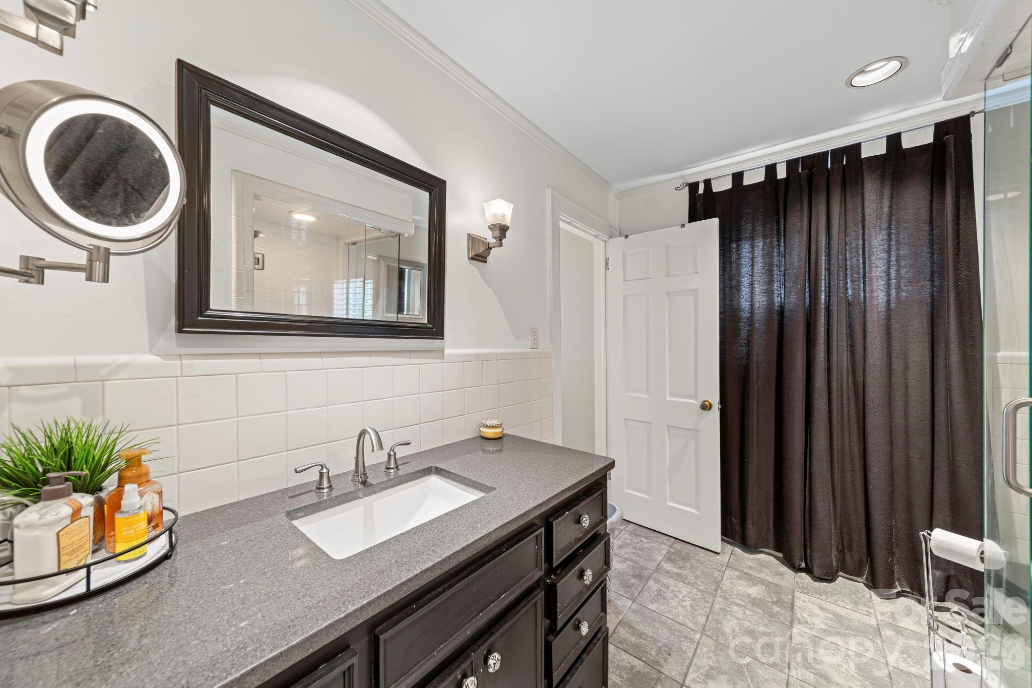 417 Park Ridge Road Albemarle, NC 28001 - Photo 25 of 47 a bathroom with a sink a mirror and a toilet
