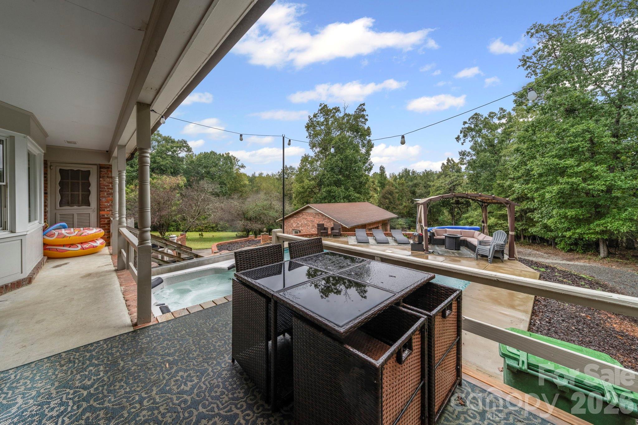 417 Park Ridge Road Albemarle, NC 28001 - Photo 46 of 47 a view of a patio with couches and table and chairs and potted plants