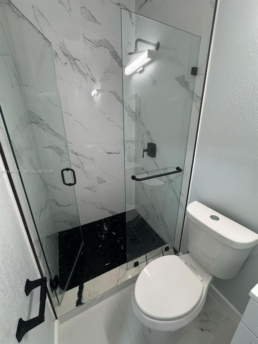 27132 Southwest 132 Ct Road Homestead, FL 33032 - Photo 2 of 4 a bathroom with a toilet and a shower