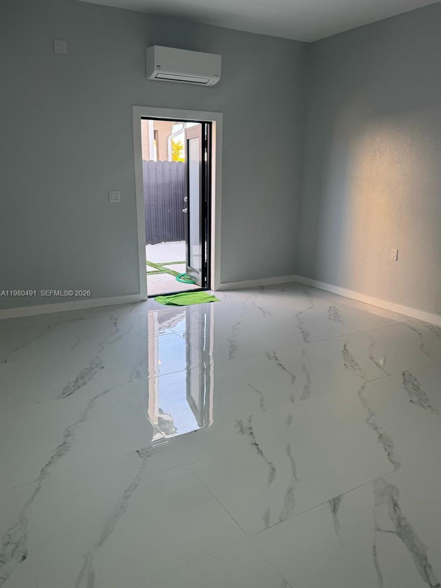 27132 Southwest 132 Ct Road Homestead, FL 33032 - Photo 3 of 4 an empty room with a window