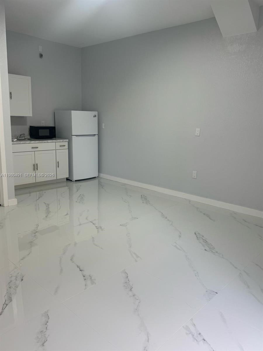 27132 Southwest 132 Ct Road Homestead, FL 33032 - Photo 4 of 4 a kitchen with white cabinets and white appliances