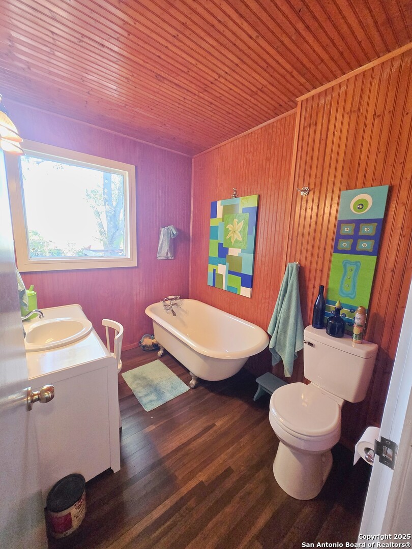 5564 Farm To Market Road 1103 Schertz, TX 78108 - Photo 14 of 35 a bathroom with a sink a toilet a mirror and shower curtain
