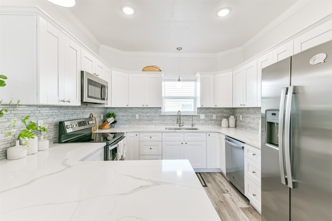 143 West Palm Surfside Beach, TX 77541 - Photo 14 of 38 a kitchen with stainless steel appliances granite countertop a refrigerator sink stove microwave and cabinets