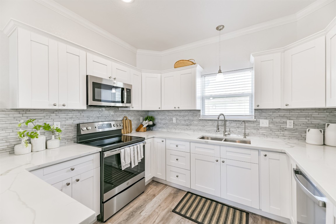 143 West Palm Surfside Beach, TX 77541 - Photo 15 of 38 White countertops and stainless appliances really make this kitchen pop!