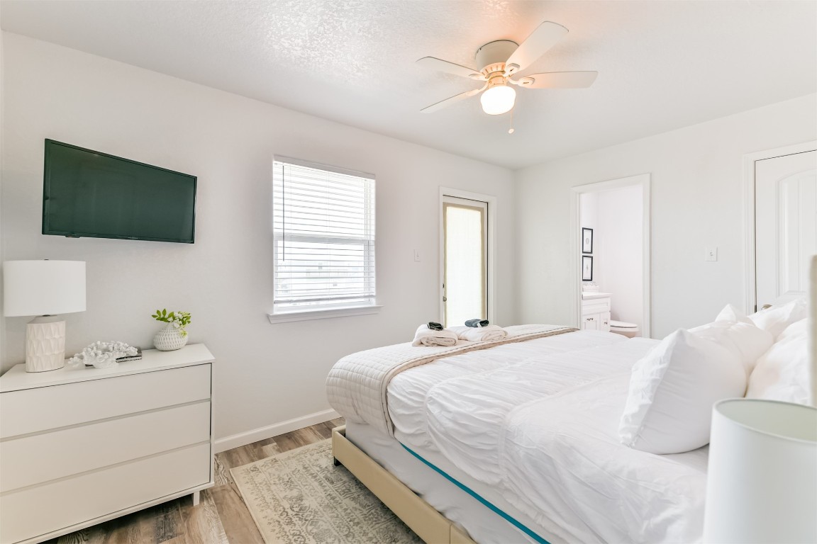 143 West Palm Surfside Beach, TX 77541 - Photo 21 of 38 a bedroom with a bed and a flat screen tv