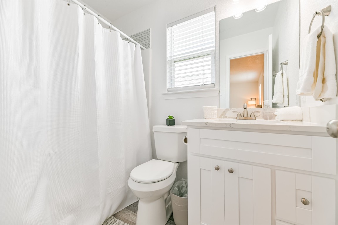 143 West Palm Surfside Beach, TX 77541 - Photo 29 of 38 a bathroom with a sink a toilet and a mirror