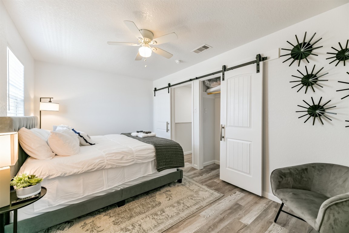143 West Palm Surfside Beach, TX 77541 - Photo 30 of 38 a bedroom with a bed couch and a potted plant