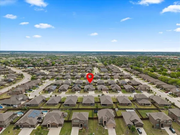 an aerial view of residential houses with outdoor space