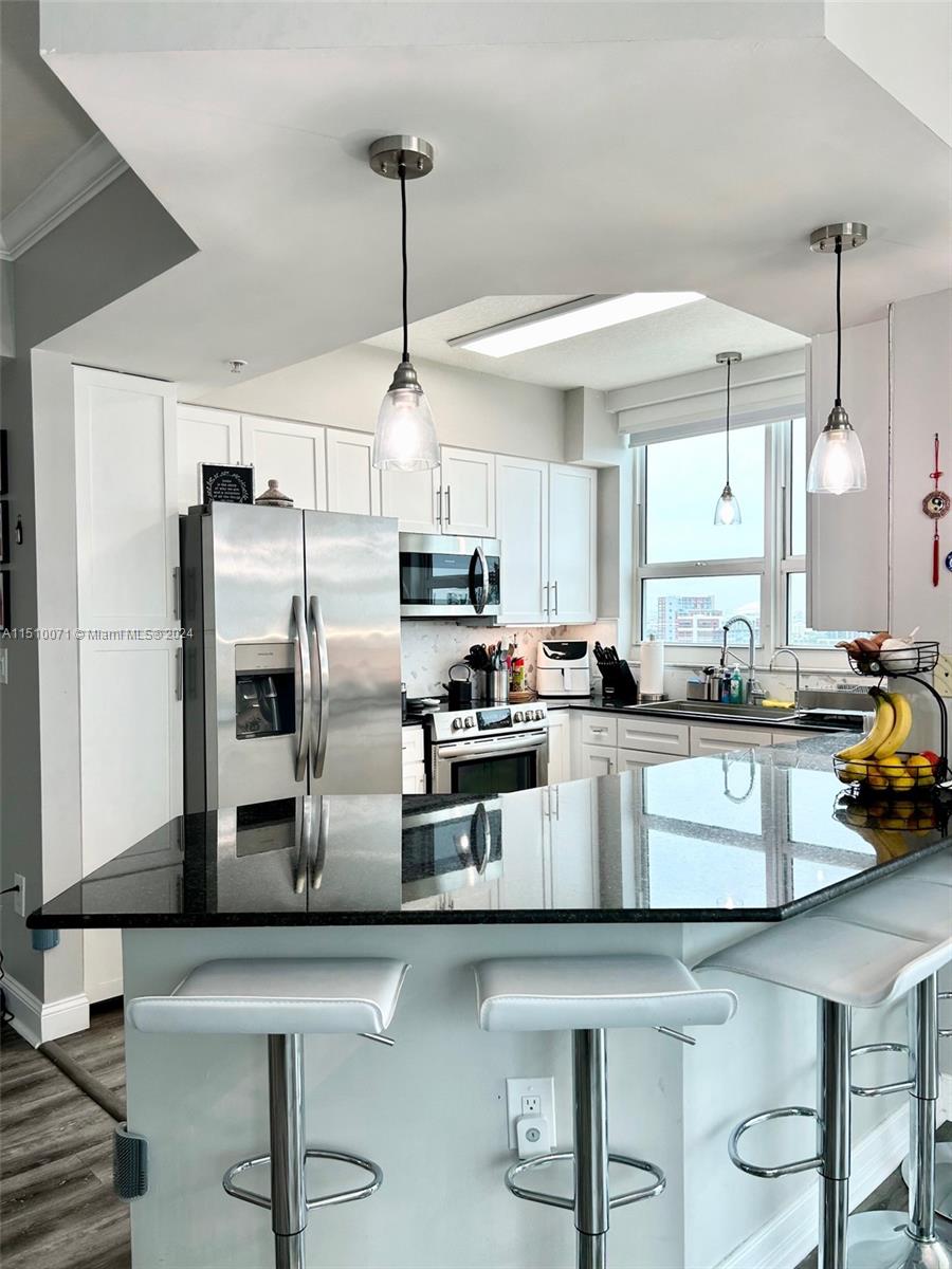 a kitchen with counter top space cabinets and stainless steel appliances