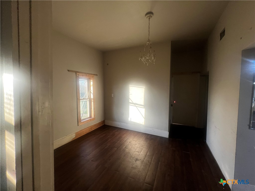 605 East Rogers Cemetery Road Rogers, TX 76569 - Photo 11 of 29 a view of an empty room with wooden floor and a window