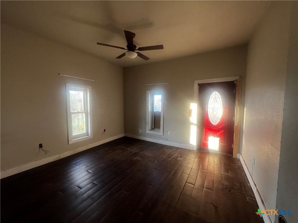 605 East Rogers Cemetery Road Rogers, TX 76569 - Photo 15 of 29 a view of an empty room with wooden floor and a window