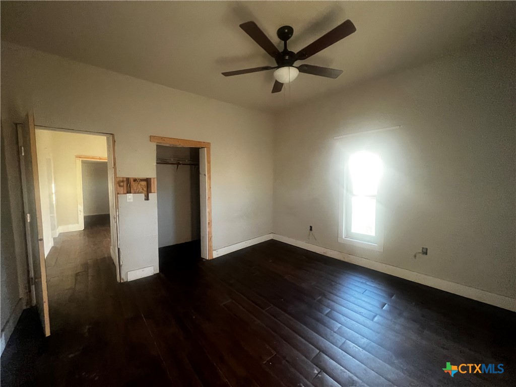 605 East Rogers Cemetery Road Rogers, TX 76569 - Photo 16 of 29 an empty room with wooden floor and windows