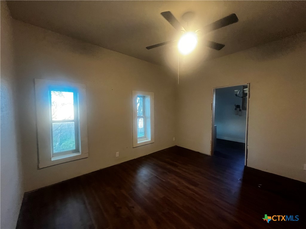 605 East Rogers Cemetery Road Rogers, TX 76569 - Photo 19 of 29 a view of an empty room with wooden floor and a window
