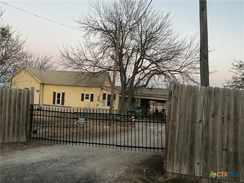 605 East Rogers Cemetery Road Rogers, TX 76569 - Photo 2 of 29 a front view of a house with a fence