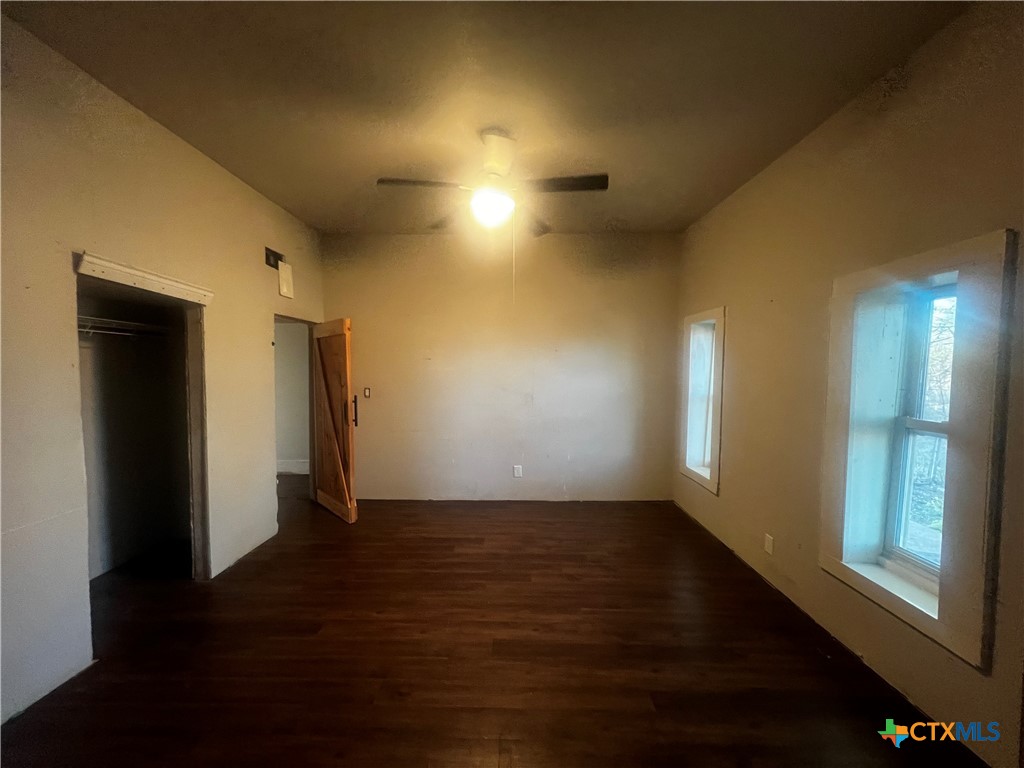 605 East Rogers Cemetery Road Rogers, TX 76569 - Photo 22 of 29 an empty room with wooden floor and windows