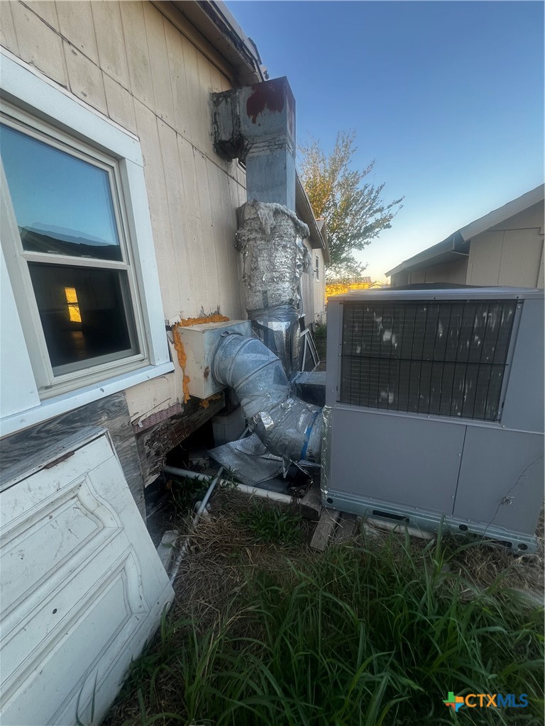 605 East Rogers Cemetery Road Rogers, TX 76569 - Photo 27 of 29 a backyard of a house with table and chairs with wooden floor
