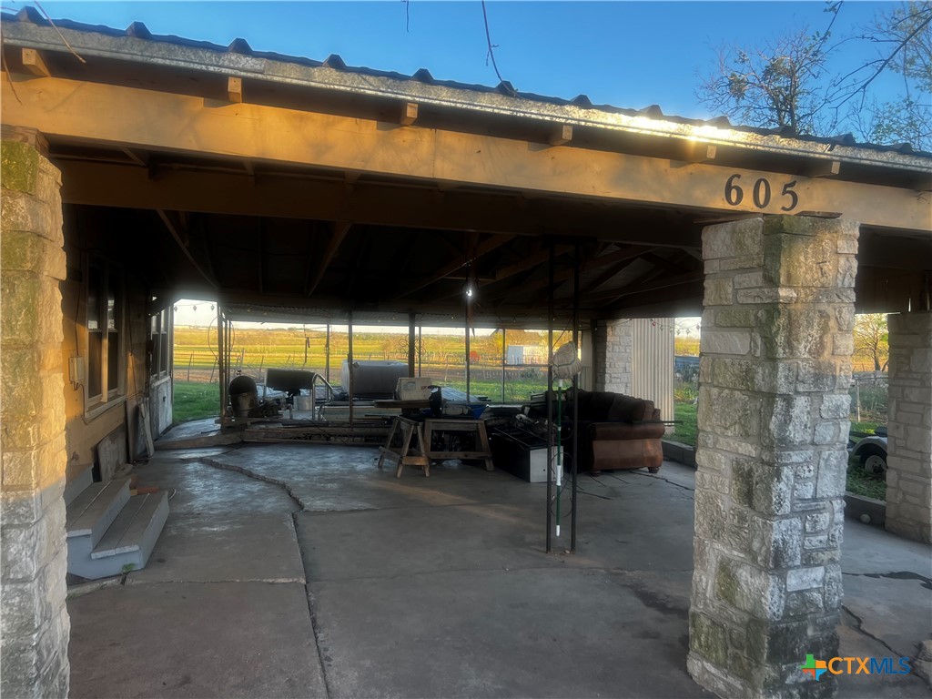 605 East Rogers Cemetery Road Rogers, TX 76569 - Photo 4 of 29 a view of a patio with table and chairs under an umbrella