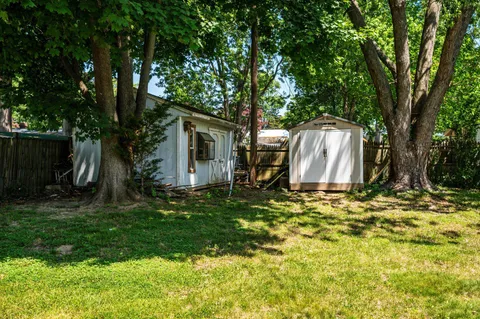 a backyard of a house with table and chairs