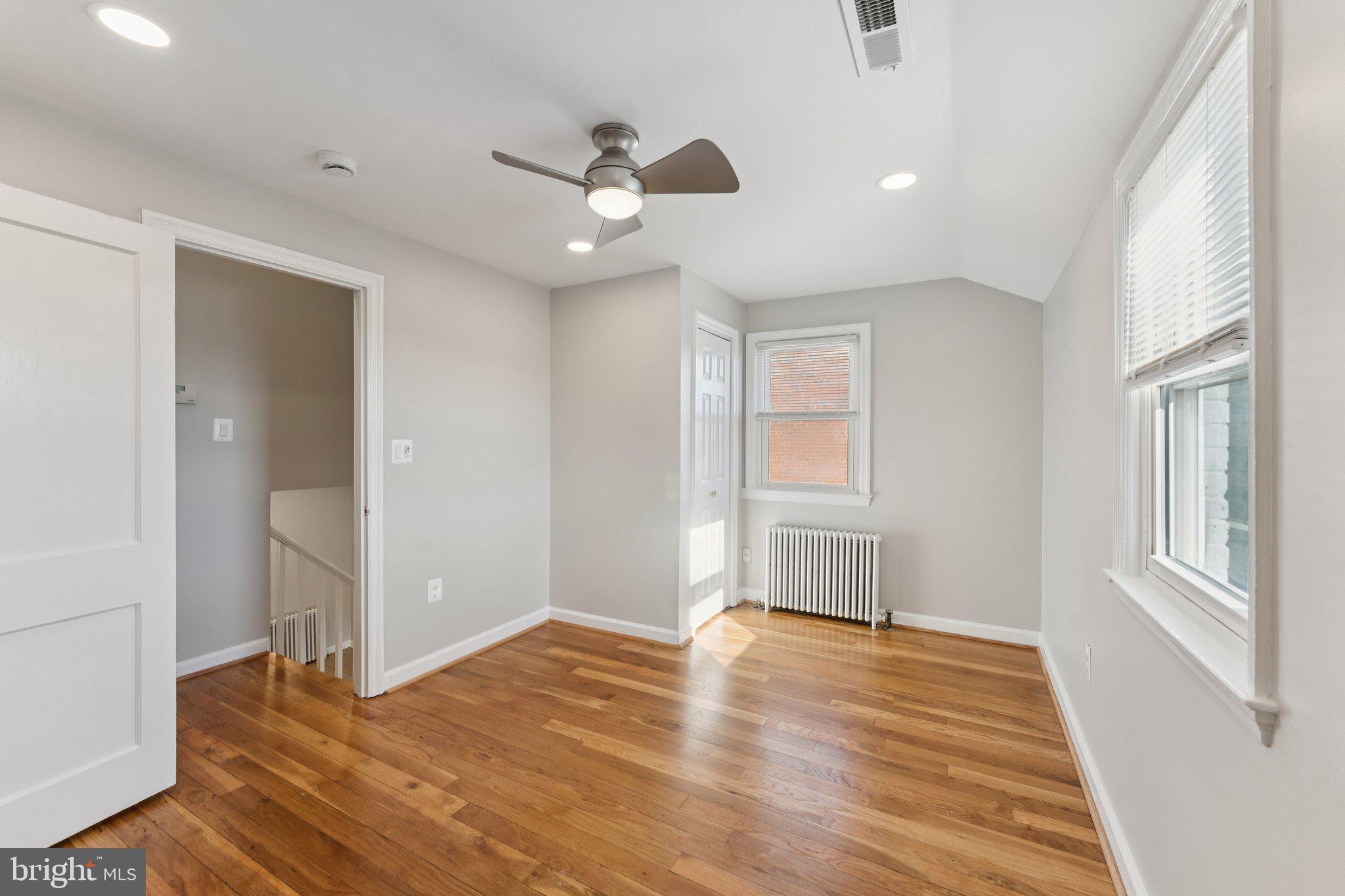 3621 South Kemper Road Arlington, VA 22206 - Photo 12 of 22 an empty room with wooden floor and windows