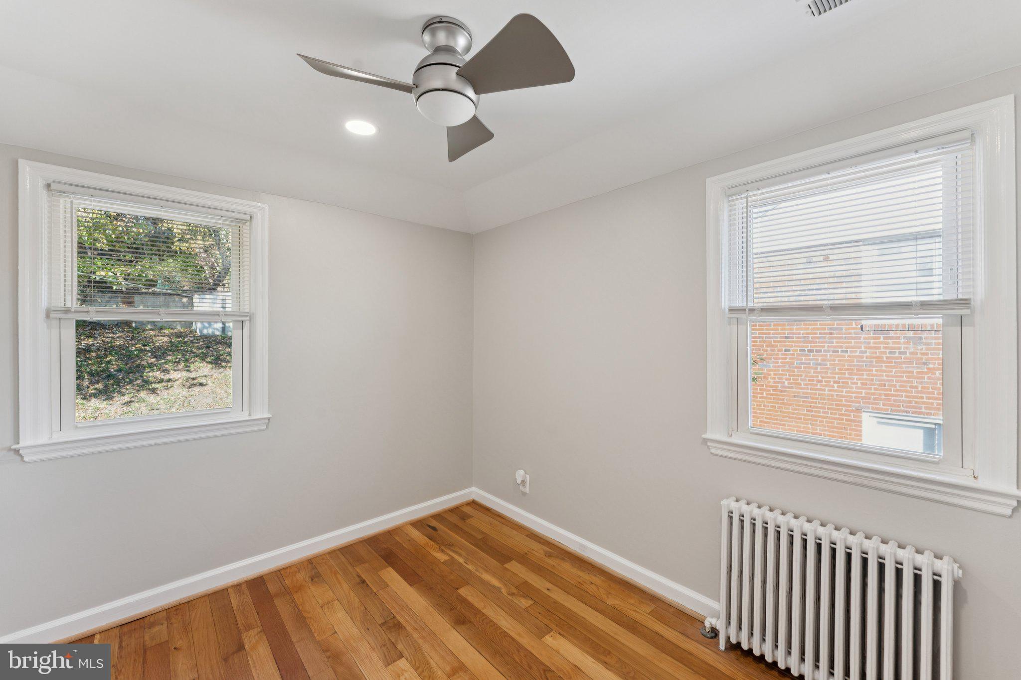3621 South Kemper Road Arlington, VA 22206 - Photo 14 of 22 a view of an empty room with wooden floor and a window