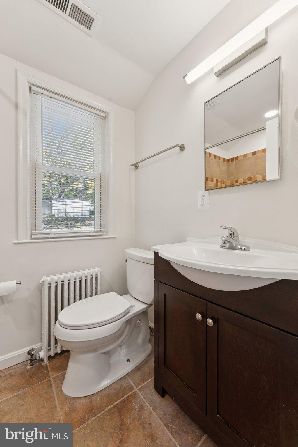 3621 South Kemper Road Arlington, VA 22206 - Photo 17 of 22 a bathroom with a sink toilet and a mirror