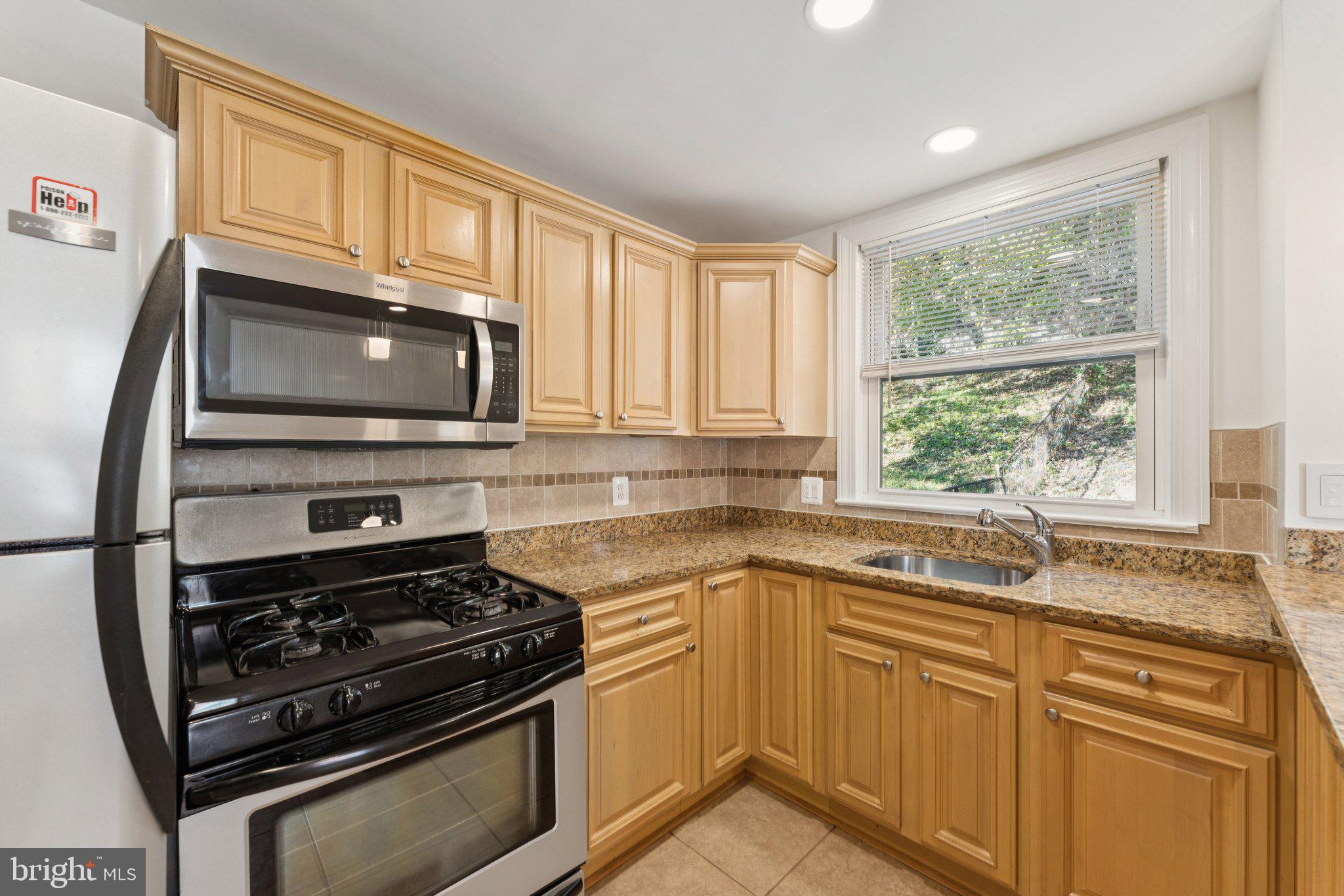 3621 South Kemper Road Arlington, VA 22206 - Photo 8 of 22 a kitchen with granite countertop a stove sink and microwave