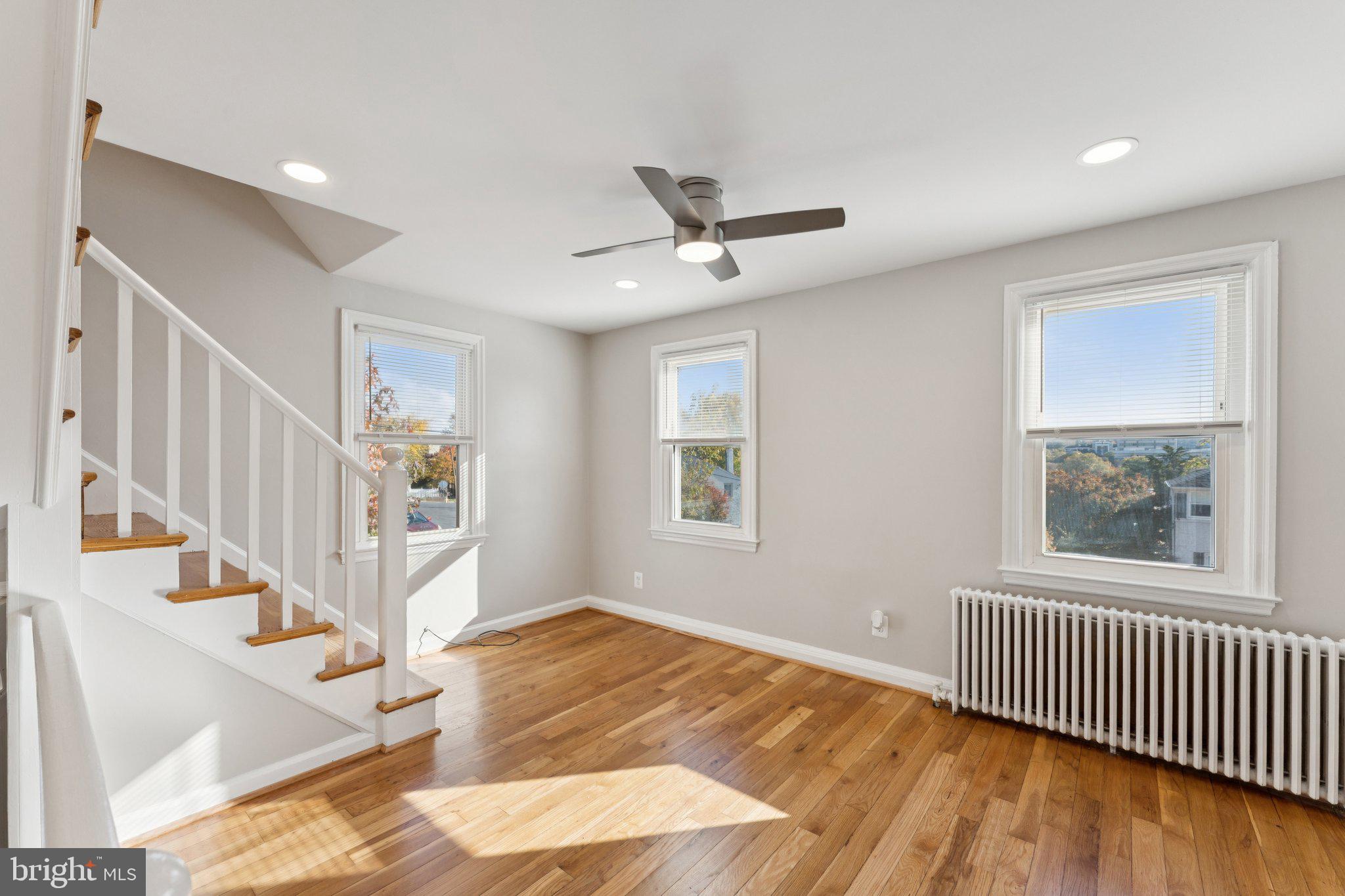 3621 South Kemper Road Arlington, VA 22206 - Photo 9 of 22 a view of an empty room with wooden floor and a window
