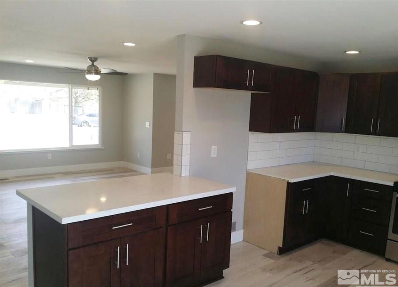 270 River Boat Road Dayton, NV 89403 - Photo 4 of 10 a kitchen with kitchen island a sink appliances and cabinets