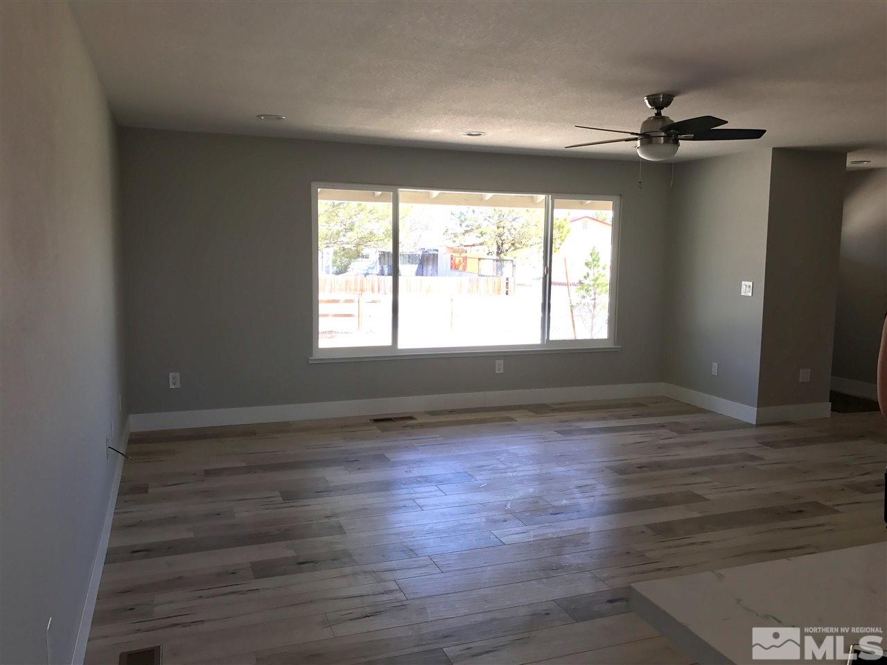 270 River Boat Road Dayton, NV 89403 - Photo 7 of 10 a view of an empty room with wooden floor and a window