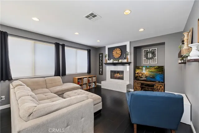a living room with fireplace furniture and a flat screen tv