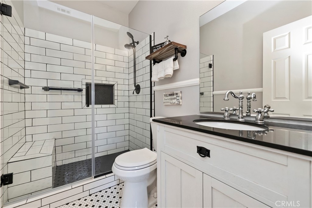 7029 Penny Court Rancho Cucamonga, CA 91739 - Photo 10 of 42 a bathroom with a sink a toilet and shower