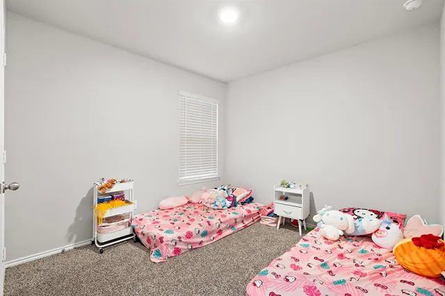 a bedroom with baby toys and dresser