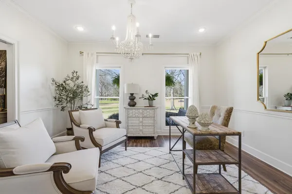 a living room with furniture and a chandelier