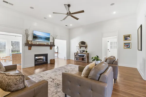 a living room with furniture fireplace and flat screen tv