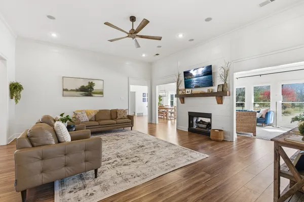 a living room with furniture a fireplace and a flat screen tv