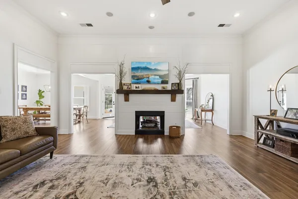 a living room with furniture a fireplace and wooden floor