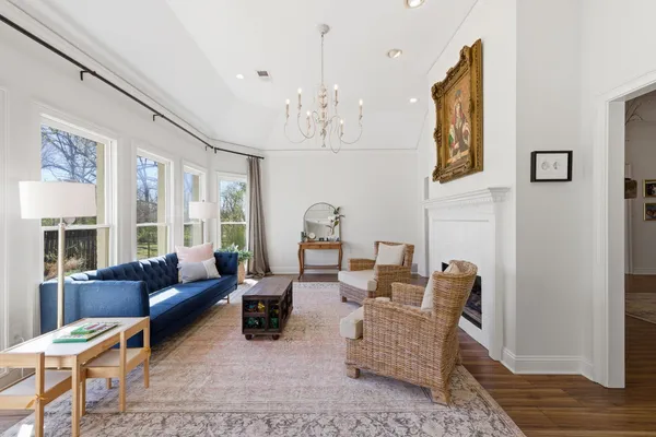 a living room with furniture and a chandelier