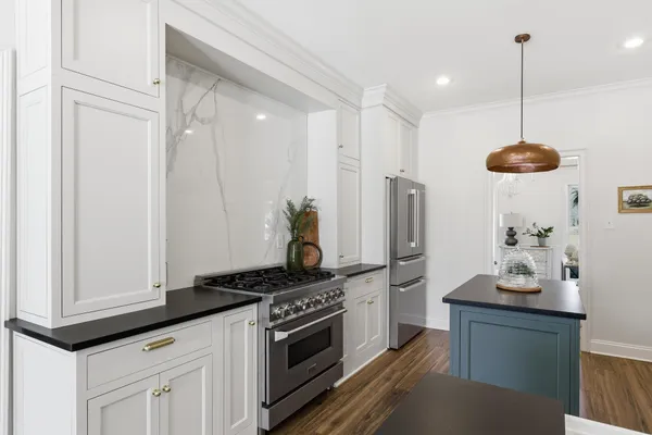 a kitchen with stainless steel appliances granite countertop a stove and a refrigerator