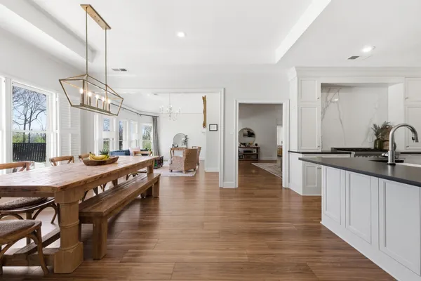 a large kitchen with lots of counter space and wooden floor