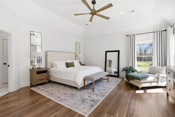 a bedroom with a bed couch and a window