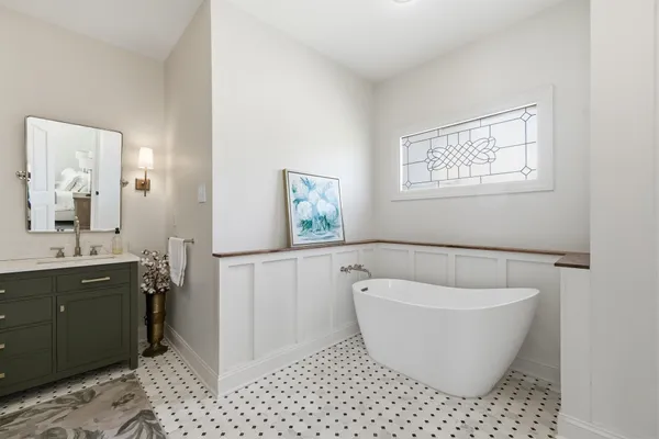 a white bath tub sitting next to a white sink