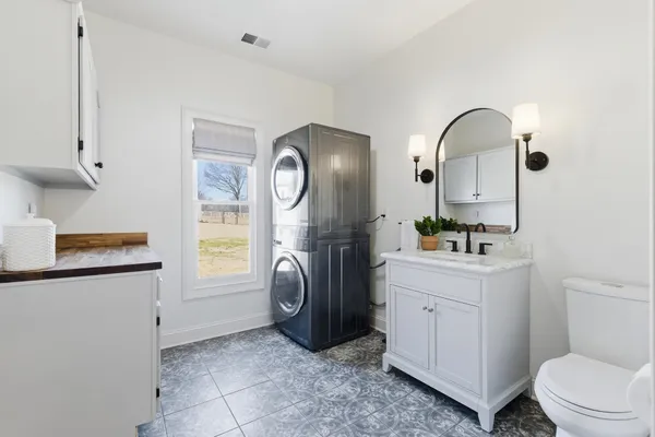 a bathroom with a sink a toilet and mirror