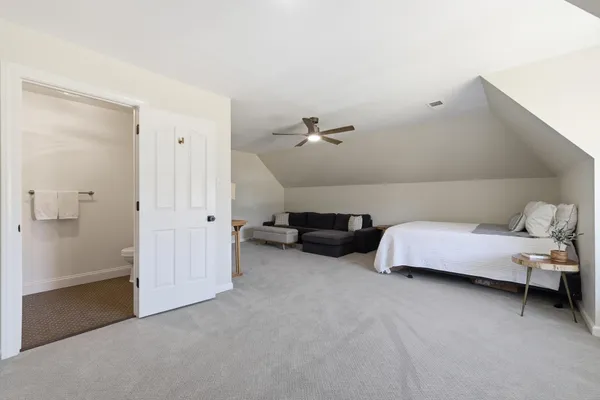 a living room with furniture and a walk in closet