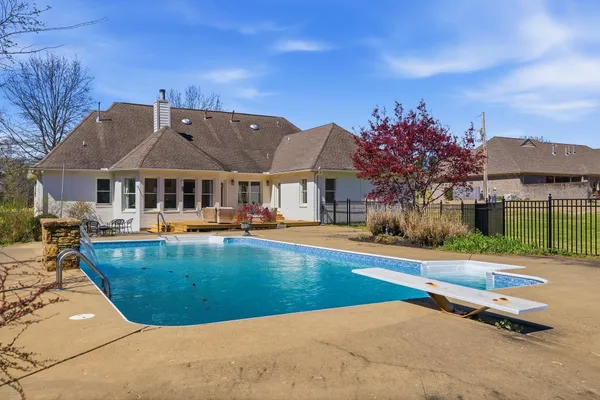 a view of a house with swimming pool and sitting area