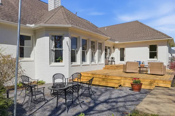a view of a house with backyard and sitting area