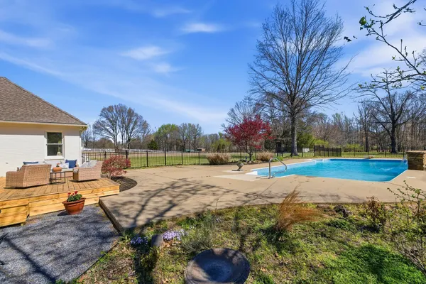 a view of a backyard with swimming pool