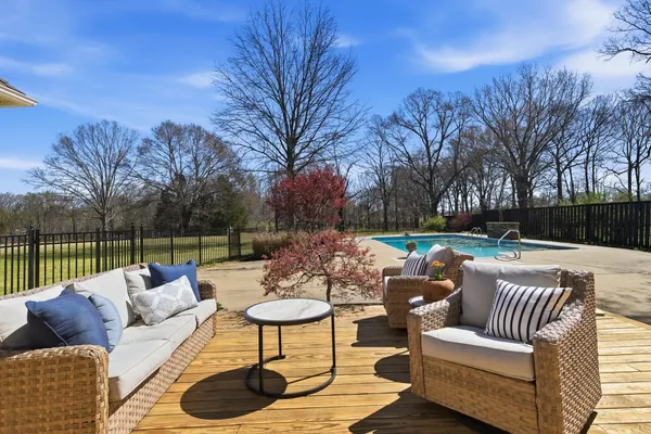 a view of a patio with couches and a fire pit
